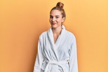 Young blonde woman wearing bathrobe with a happy and cool smile on face. lucky person. - obrazy, fototapety, plakaty