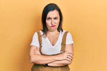 Obraz premium Middle age hispanic woman wearing casual clothes skeptic and nervous, disapproving expression on face with crossed arms. negative person.