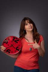 woman holding a red clock
