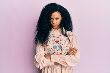 Middle age african american woman wearing casual clothes skeptic and nervous, disapproving expression on face with crossed arms. negative person.