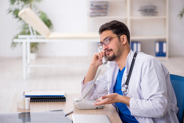 Young male doctor in telemedicine concept