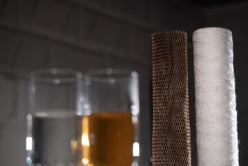Filters for water. New clean and old dirty filter cartridge rusty.