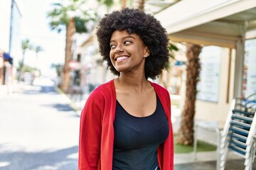 Young african american girl smiling happy standing at the city.