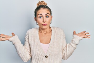 Young caucasian woman wearing casual clothes clueless and confused with open arms, no idea and...