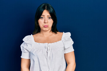 Young hispanic woman wearing casual clothes depressed and worry for distress, crying angry and afraid. sad expression.