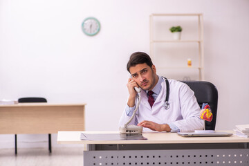 Young male doctor cardiologist working in the clinic