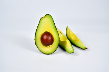 Fresh avocado cut in half with seed  isolated on white background.