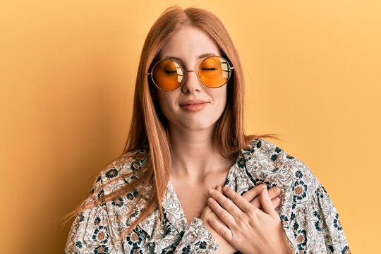 Young irish woman wearing bohemian and hippie style smiling with hands on chest with closed eyes and grateful gesture on face. health concept.