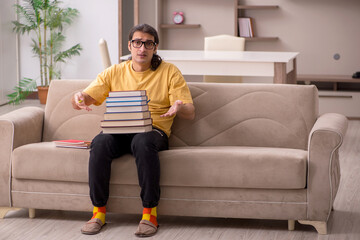 Young male student preparing for exams at home