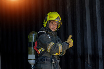 Fototapeta premium Fireman wearing firefighter turnouts holding helmet ready for emergency service,Fireman in emergency situation.