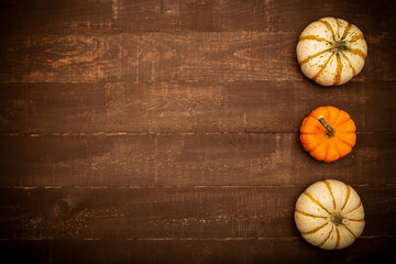 Fall top view background composition. Pumpkins on rustic wooden table. Happy Thanksgiving concept. Fall concept. Flat lay, top view, copy space