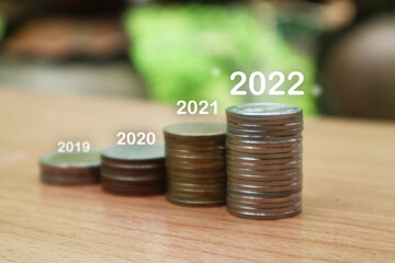 Growing Money, business finance and saving money investment , Money coin stack growing graph, plant growing up on coins. Balance savings and investment. growing growth year 2020 to 2022 concept.