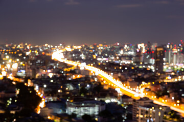 Fototapeta na wymiar Blur bokeh background with cityscape in twilight, blurred focus in evening with downtown, landscape, illuminated and light.