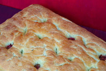 A rectangular focaccia bread with fresh figs and rosemary