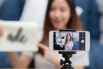 Young asian woman is teacher teaching language english with student for e-learning online at home, girl working and talking lesson in class with smartphone, stay home, new normal, education concept.