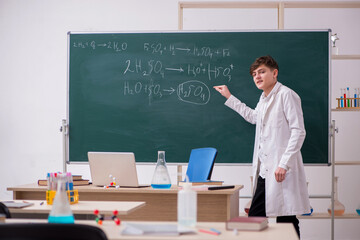 Schoolboy studying chemistry in the classroom