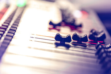 Professional audio mixing console with faders and controls.