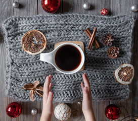 Flat lay christmas composition with cup, knitted element and christmas decor.