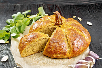 Bread pumpkin cut on a black board