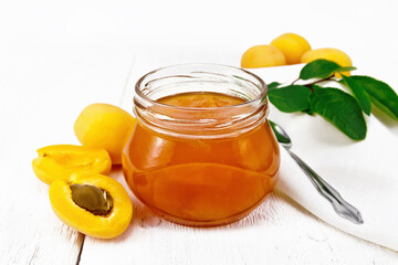 Jam apricot in jar on white board