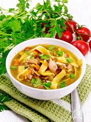 Soup with mung and noodles in bowl on towel