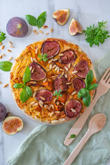 Home made autumn quiche with pumpkin and figs on a table