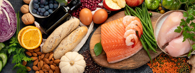 Healthy food assortment on dark background.
