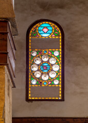 Perforated stucco window decorated with colorful stain glass with geometrical circular patterns, located at Mamluk era public historical Beshtak Palace,, Moez Street, Cairo, Egypt