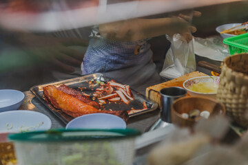 Egg noodle and barbecue roast pork and cantonese lettuce vegetable in food cabinet at street food shop.