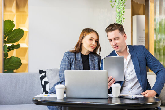 Caucasian business people is working on new strategic planning for next year using laptop while working in green building eco friendly modern working space surrounded by air purifying house plant