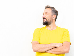 One positive man with yellow shirt portrait against wall - Powered by Adobe