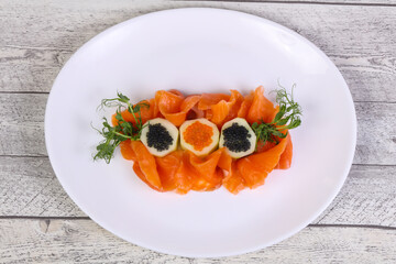 Sliced salmon with caviar