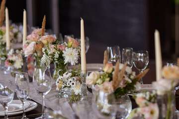 A very nicely decorated wedding table appointments with beautiful decor with plates and serviettes in spring garden. Beautiful flowers on table in wedding day. The elegant dinner table.