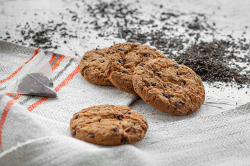 Stack of delicious chocolate cookies on a gray background
