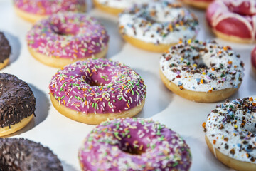 donuts with different flavors, fillings and different sprinkles