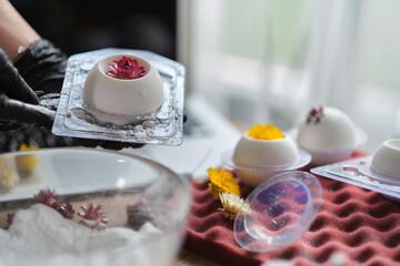 handmade bath bombs process. Preparation of bath bombs. Ingredients and floral decor on a wooden vintage table.
