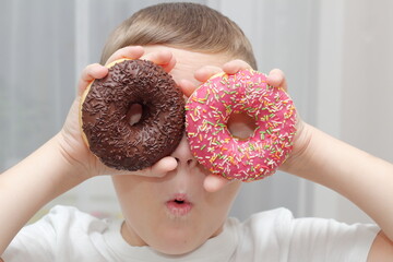 little child eating a donut