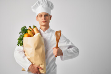 male chef with a package of groceries restaurant cooking professional