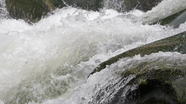Seething crystalline waters rushing over rocky cascade in the Carpathians 