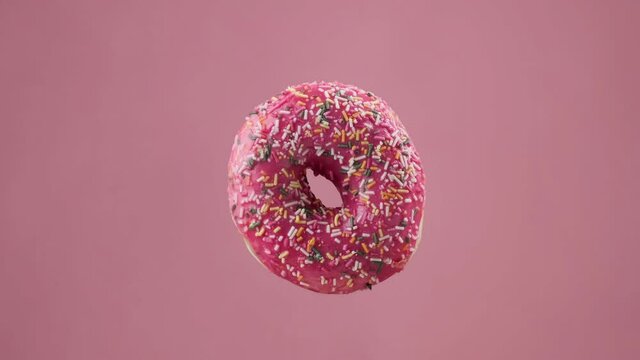 Various colorful donuts. Different delicious donuts changing at pink background. Chocolate, pink, blue glazed donuts. Stop motion. Unhealthy food. Bakery and food concept in 4K, UHD