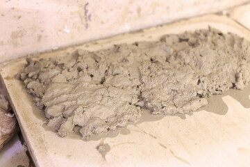 Clay ready for shaping on table in pottery art workshop.