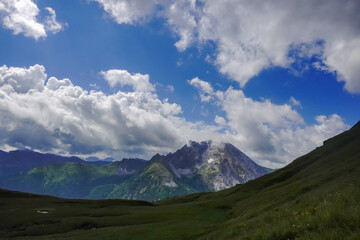 high rocky mountains with amazing clouds on the blue sky in austria