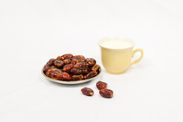Dates and a glass of milk isolated on a white background