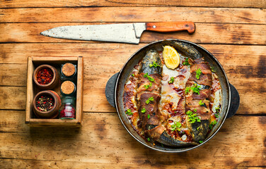 Baked fish wrapped in bacon