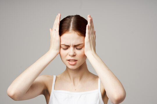woman in white t-shirt headache health problems stress isolated background