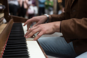 Fototapeta na wymiar closeup of hands of musician on piano keyboard