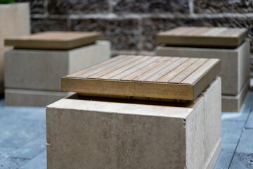 outdoor wooden chair in shared city space, for relaxing on during lunch break