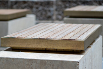 outdoor wooden chair in shared city space, for relaxing on during lunch break