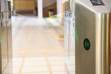 Pedestrian access control flap barriers, with card readers as security access controls to prevent unauthorized access to the school.
