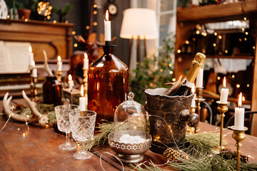 Christmas served wooden table with glasses, candles and champagne. 